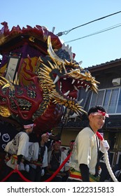 Karatsu, Japan - november 3, 2018 : people in traditional costumes drawning "The Boat of seven treasures" float through the street during Karatsu city annual "kunchi" parade
