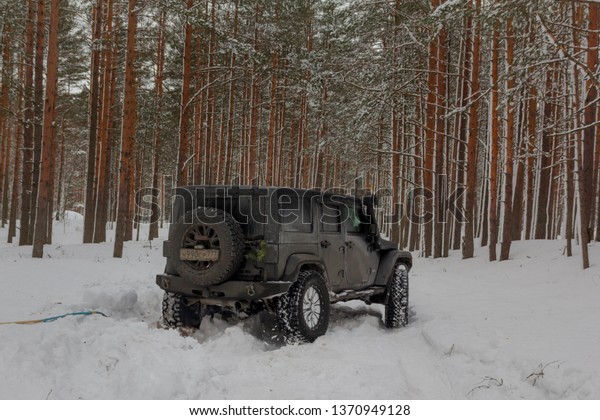 Karelia, Russia, February 18, 2019: jeep\
Wrangler in the Karelian winter forest. Wrangler is a compact four\
wheel drive off road and sport utility\
vehicle