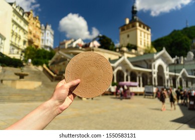 Karlovy Vary, Czech - July 2 2019: Hand with traditional spa waffle of Karlovy Vary - Karlsbad Oblaten, oplatky