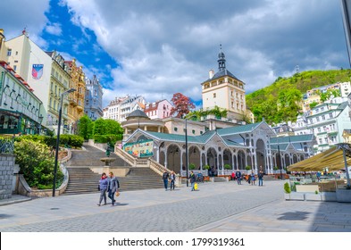 Karlovy Vary, Czech Republic, May 10, 2019: The Market Colonnade Trzni kolonada wooden colonnade with hot springs and people are walking in town Carlsbad historical city centre, West Bohemia