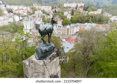 Karlovy Vary, Czech Republic - May 07, 2022: View of the Goat sculpture (made in 1851) on the rock, one of the symbols and landmarks of the city.