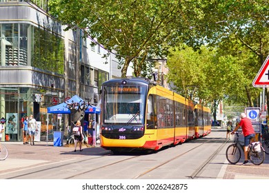 Karlsruhe, Germany - August 2021: Regional streetcar driving through city center on a sunny summer day