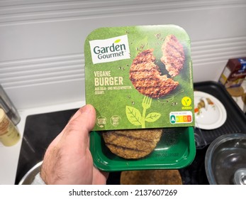 Karlsruhe, Germany - March 11, 2022: POV Male Hand Holding The Package With Vegan Burger Manufactured By Garden Gourmet - Bio Organic Food