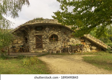 Karlukovo, Lukovid, Bulgaria - October 4, 2020: Stone house near Karlukovo village, Bulgaria. The roof is covered with grass. Cloudy day.