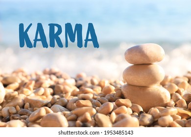 Karma Concept. Stack Of Stones On Pebble Beach