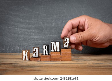 KARMA. Wooden letters, alphabet blocks on steps. development and growth concept. - Powered by Shutterstock