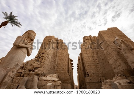 Karnak Temple Complex in Luxor. A famous ancient Egyptian temple ruin with colossal statue of Ramses II.