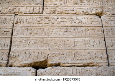 KARNAK TEMPLE - Massive columns inside beautiful Egyptian landmark with hieroglyphics, and ancient symbols. Famous landmark in the world near the Nile River and Luxor, Egypt