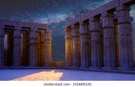 Karnak Temple, The ruins of the temple, Embossed hieroglyphs on the wall. The night sky.
