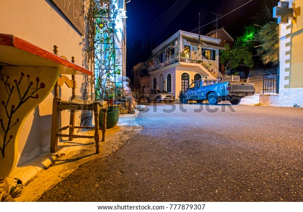Karousades, Corfu, Greece - August 31, 2017: night\
cityscape of old mediterranean village with narrow streets and\
antique houses
