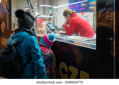 Karpacz, Poland -  February 2018 : Family Queuing And Waiting For Sweet Waffles Or Gaufres Sold From A Street Vendor On A Tourist Promenade In Polish Ski Resort Town