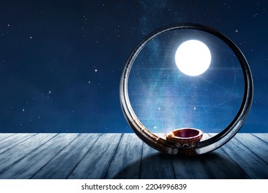 Karwa Chauth strainer and Diya oil lamps for the Karwa Chauth celebration on the night - Shutterstock ID 2204996839