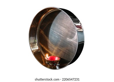 Karwa Chauth strainer and Diya oil lamps for the Karwa Chauth celebration are isolated over white background