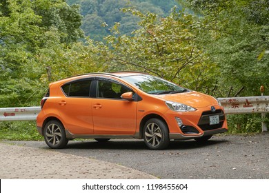 KASAGI, JAPAN - SEPTEMBER 16, 2018: Toyota Aqua compact car on a mountain road. Also known as Prius C outside of Japan, One of the most fuel efficient hybrid vehicles