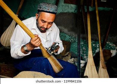 Kashgar / China - MAY 24 2011 : Uyghur Man Making An Instrument Called Dutar A Local Violin Version