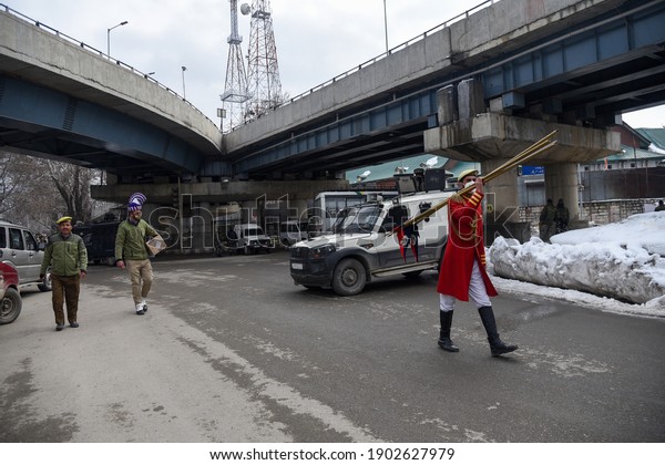 26-January-2021—Srinagar, Kashmir, India:\
Members of Indian police walk on an empty road leading to Indian\
republic day venue after performing in\
Srinagar.