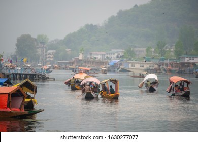 KASHMIR, INDIA-APRIL 15, 2019: Dal lake, the tourist attractive destination in northern India. People use 'Shikara" a small boat for traveling and transportation in the lake in Srinaga, Kashmir, India
