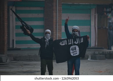 Kashmiri masked protester waving flags during clashes in Nowhattah Srinagar after Friday prayers on 21st December 2018