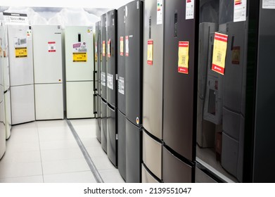 Kassel, Germany - March 28, 2022: Row of Refrigerator in Hypermarket store. Exposition sale of refrigerators in a household appliances store. Rows of refrigerators in appliance store