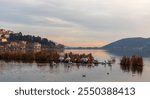 Kastoria City and Orestiada Lake Under Soft Sunlight and pelicans