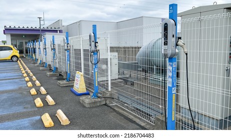 Kasukabe, Saitama, Japan. August 5, 2022. A Row Of NEC Corp. Standard Electric Vehicle Chargers Atop A Rooftop Parking Lot At An AEON Shopping Mall With A Single Car Charging At One Of The Stations. 