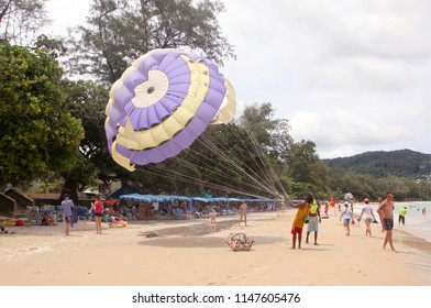KATA BEACH, PHUKET, THAILAND - JUNE 15, 2018: Unidentified tourists prepare for parasailing on Kata beach, Phuket, Thailand