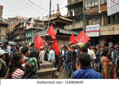 Kathmandu, Nepal - 9/23/2016: Small Communist Party Procession Going Through A Crowd On A Local Street Market