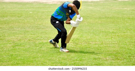 Kathmandu, Nepal - April 10, 2022: Young man doing batting practice in a ground