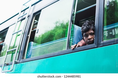 KATHMANDU, NEPAL - APRIL 2015: Young Sad Boy Looking Out Of The Bus Window.