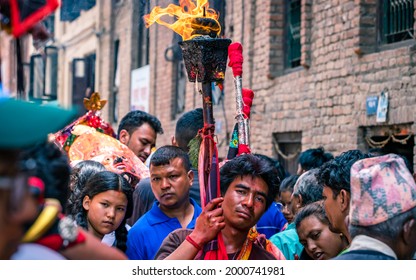 Kathmandu, Nepal - August  20, 2019: people carrying traditional oil lamp during the Nil Barahi dance festival at Bode in Bhaktapur.