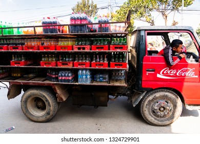 KATHMANDU, NEPAL - DEC 10, 2018: Old open truck delivers Coca Cola to local shops and vendors.