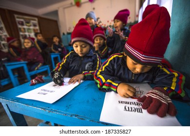 KATHMANDU, NEPAL - DEC 24, 2013: Unknown pupils in English class at primary school. Only 50% of children in Nepal can reach 5 grade.