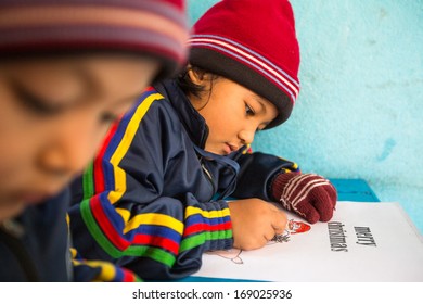 KATHMANDU, NEPAL - DEC 24: Unknown pupils in English class during preparation of the Christmas at primary school, Dec 24, 2013 in Kathmandu, Nepal. Only 50% of children in Nepal can reach 5 grade.