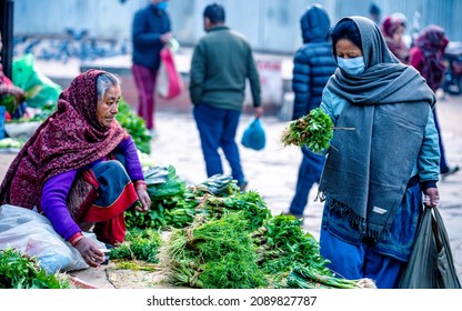 KATHMANDU, NEPAL - December 11, 2021: People Wearing Mask And Selling Vegetables On Street Market, Daily Stuggle Life Of Street Vendor During Covid Pandemic At Kathmandu.
