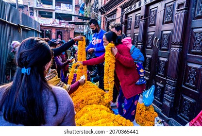 Kathmandu, Nepal - November 04, 2021: street vender selling fresh marigold flower garland on street during Tihar festival at Kathmandu. 