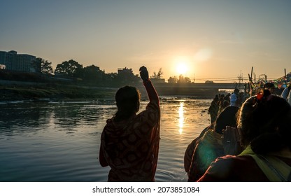 KATHMANDU, NEPAL - NOVEMBER 11, 2021: An ancient Hindu festival, dedicated to Lord Surya and Chhathi, A devotee prepairing goods during the “Chhath” festival at River in Kathmandu.
