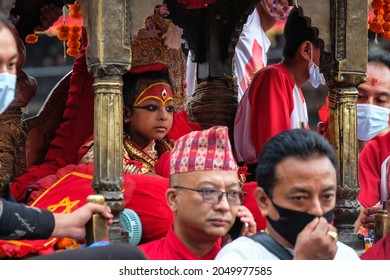 Kathmandu, Nepal - September 2021: The living goddess Kumari looking out into the crowd during the annual Indra Jatra festival in Durbar Square on September 24, 2021 in Kathmandu, Nepal.