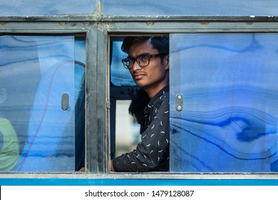 Kathmandu / Nepal - September 26 2015: Portrait Of A Man Sat In A Bus Looking Out A Window.