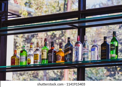 Kathmandu,Nepal - Dec 16,2017: Different Brands Of Booze, Liquor, Or Alcohol In A Bar Or Tavern. Multiple Bottles Of Adult Beverages  At Bar, Line Of Liquor Bottles