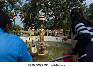 Kathmandu,Nepal - October 18 2018 : nepalese throw coin to buddha image in middle of holy pond to wish happy in monkey temple (Pashupatinath Temple) in Kathmandu ,Nepal