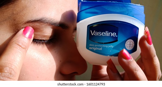 Katni, INDIA - December 2019: An Indian Girl Applying Vaseline Moisturising Cream On Eyelid 