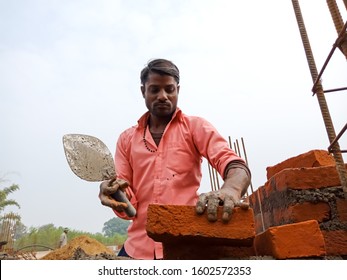 Katni, INDIA - December 2019: Indian Labour Fixing Bricks During Home Construction At Sky Background 