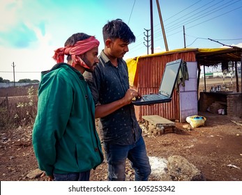 Katni, INDIA - January 1, 2020: Indian Village Labour Operating Laptop Computer At Blue Sky Background 