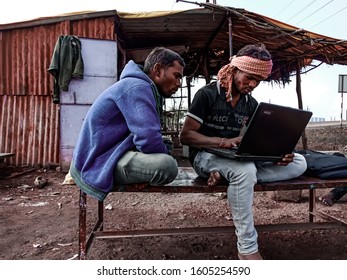 Katni, INDIA - January 1, 2020: Indian Village Labours Operating Laptop Computer Seating At Bench 