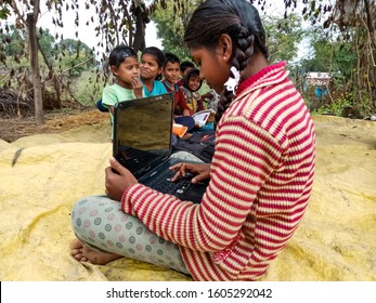 Katni, INDIA - January 1, 2020: An Indian Village Girl Operating Laptop Computer System At Open Area Background 