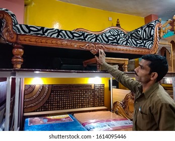 Katni, INDIA - January 2020: Asian Salesmen Displaying Furniture Object For Sale At Showroom 