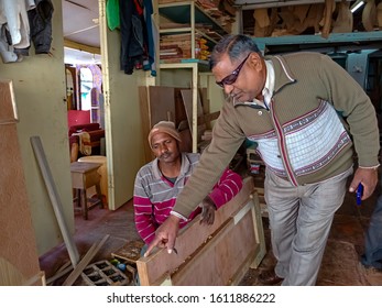 Katni, INDIA - January 2020: Furniture Shop Owner Instructing Carpenter During Work At Workshop 