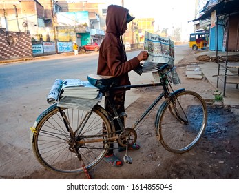 Katni, INDIA - January 2020: An Indian Newspaper Howker Boy Riding Bicycle On Road 