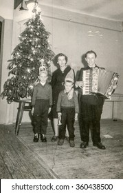 KATOWICE, POLAND, CIRCA 1939: Vintage Photo Of Family With Accordion Posing In Front Of Christmas Tree 