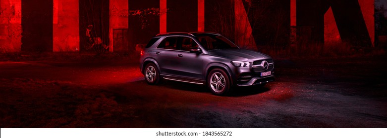 Katowice/Poland - 01.12.2020: Mercedes GLE against the background of a mural by the artist SpY, created in 2013 as part of the Katowice Street Art Festival.